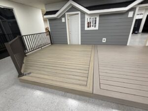 An indoor display showcasing gray siding and composite decking options by Stephenson Exteriors LLC in Cincinnati, OH.