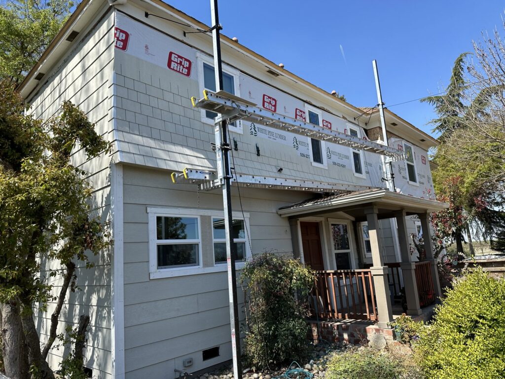 Siding installation in progress on a residential home by Bushco Contracting LLC in Fresno, CA.