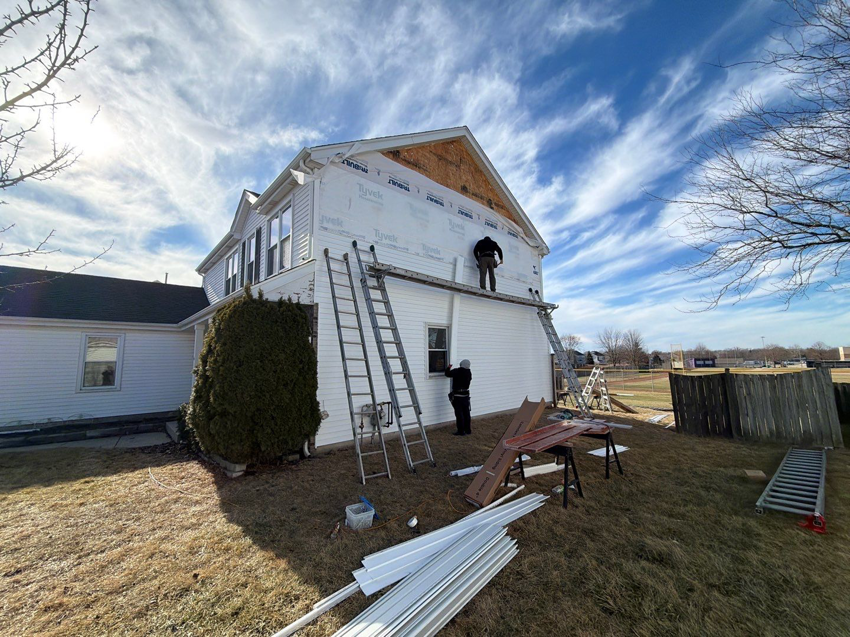 Siding installation in progress on a residential home by Legend Exteriors & Construction in West Chicago, IL