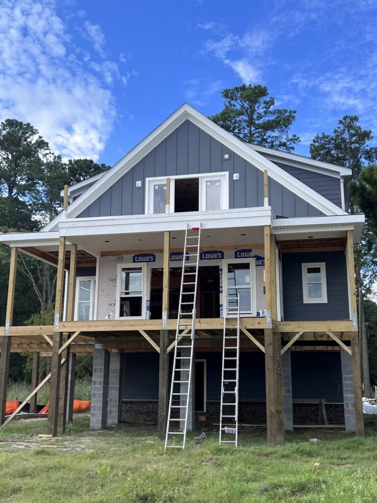 New construction home with dark blue siding being installed by Cordell Exteriors Inc in Chesapeake, VA