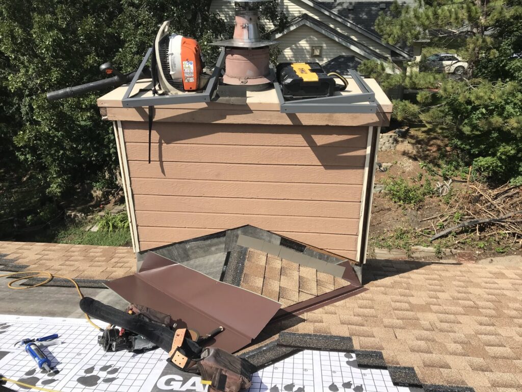 Siding installation in progress on a residential chimney, showing new siding panels, by Archcraft Exteriors in South Saint Paul, MN.