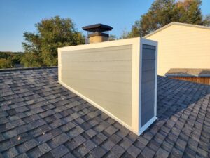 New gray siding installed on a residential chimney by EZ General Construction, a specialized service in Colorado Springs, CO.