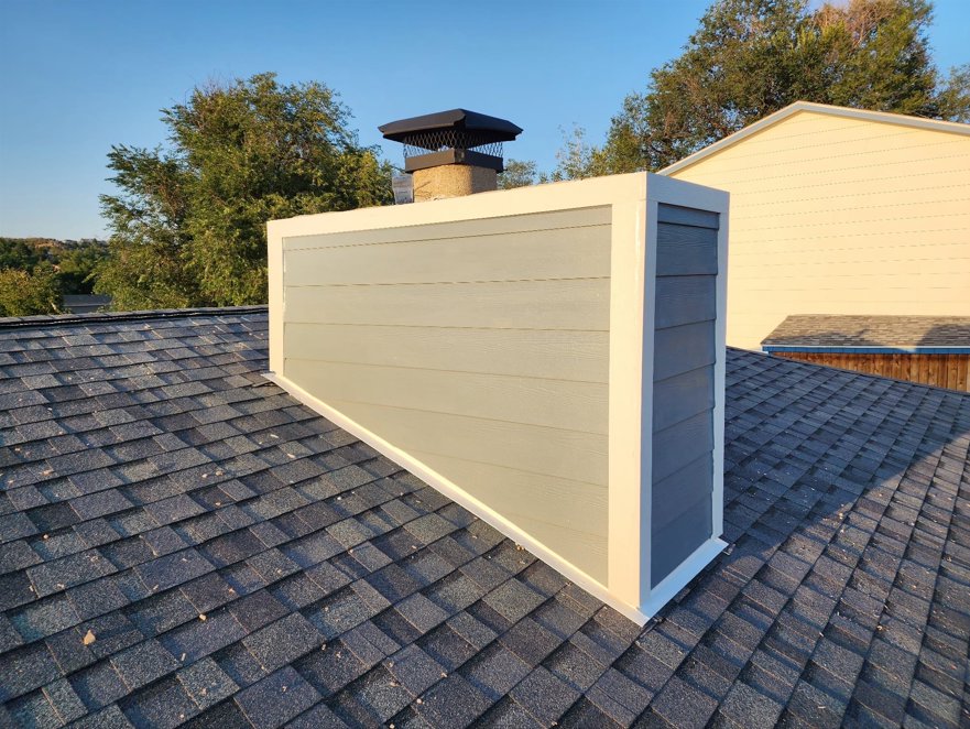 New gray siding installed on a residential chimney by EZ General Construction, a specialized service in Colorado Springs, CO.