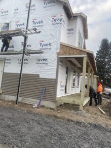Siding installation in progress on a new home with Tyvek house wrap by JHV Roofing in Scranton, PA.