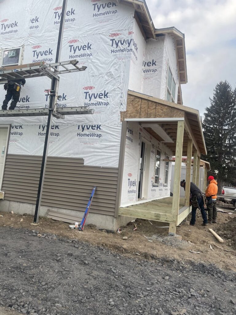 Siding installation in progress on a new home with Tyvek house wrap by JHV Roofing in Scranton, PA.