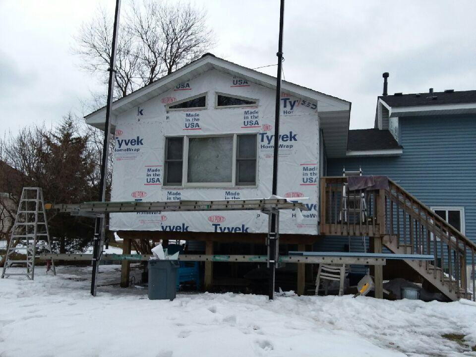 House with Tyvek house wrap and ladders set up for siding installation by Capital Siding, Windows & Roofing, Woodbury, MN.