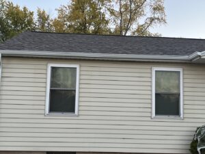 Siding installation in progress on a house, showing blue siding and Norandex house wrap by Wisconsin Exteriors in Kaukauna, WI.