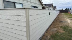 A newly installed privacy wall made of horizontal siding panels by Bushco Contracting LLC in Fresno, CA.