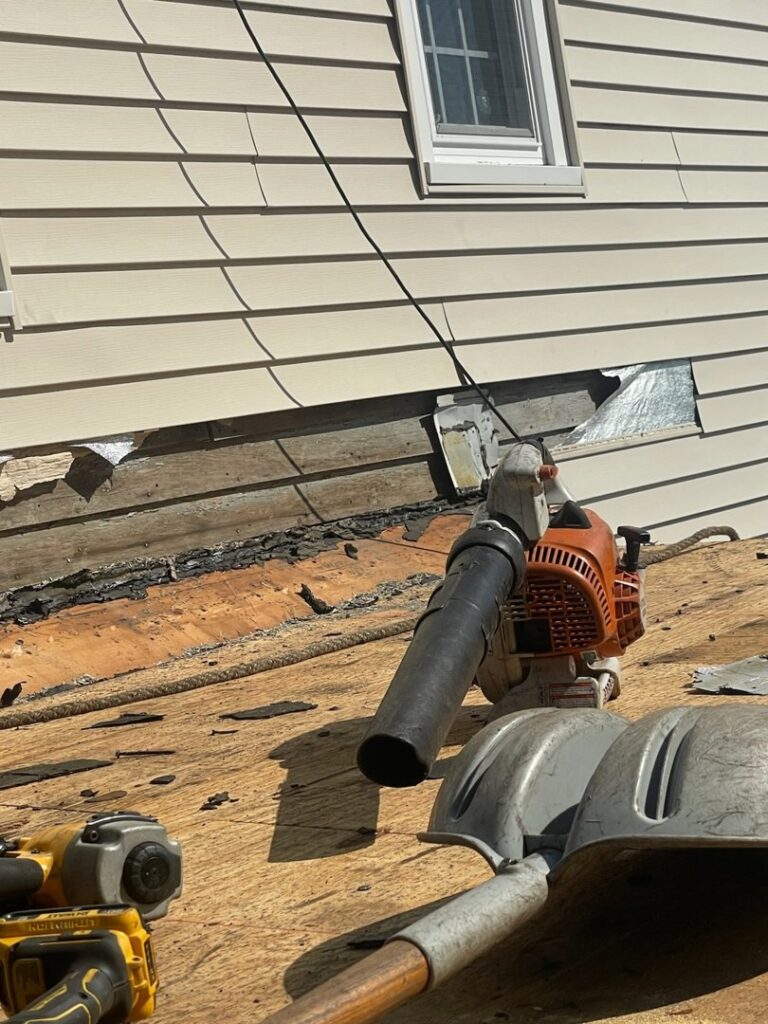 Close-up of siding removal and wall repair in progress on a house by Pride Exteriors in North Attleborough, MA.