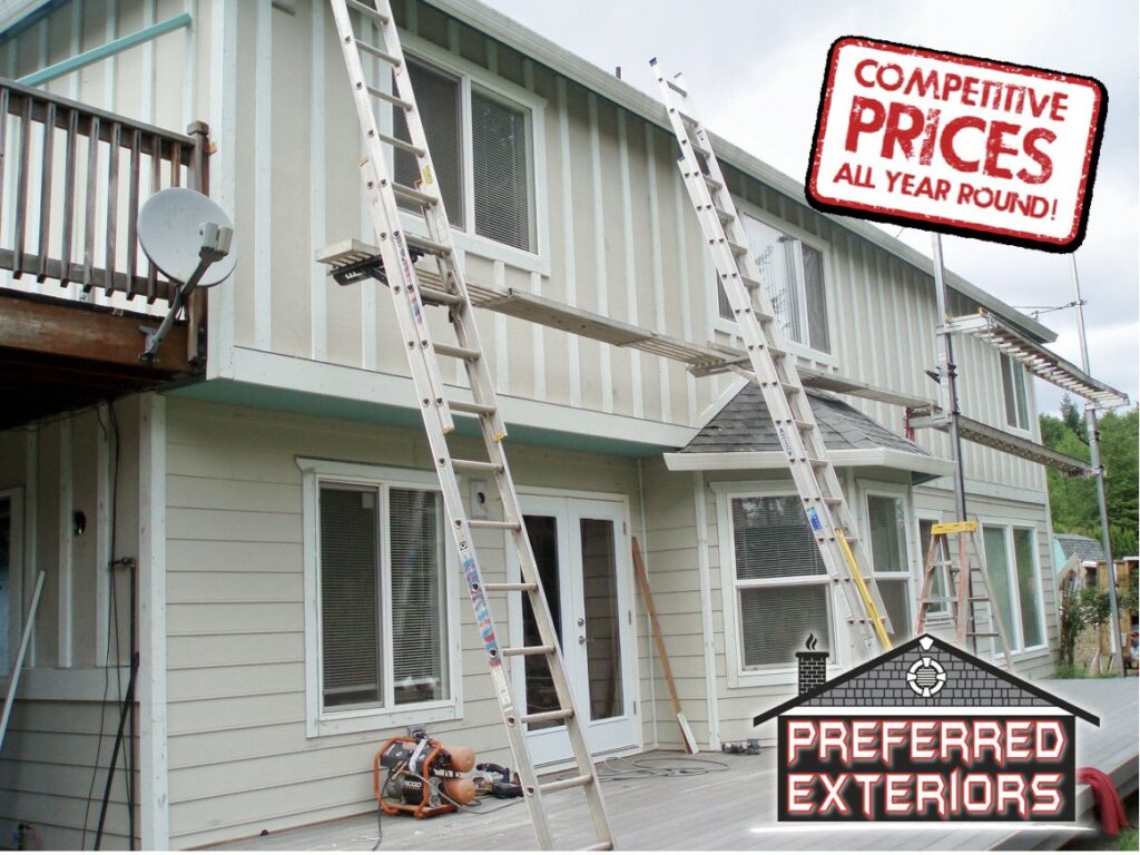 Siding removal and installation in progress on a house, showing ladders and scaffolding by Preferred Exteriors in Roswell, GA