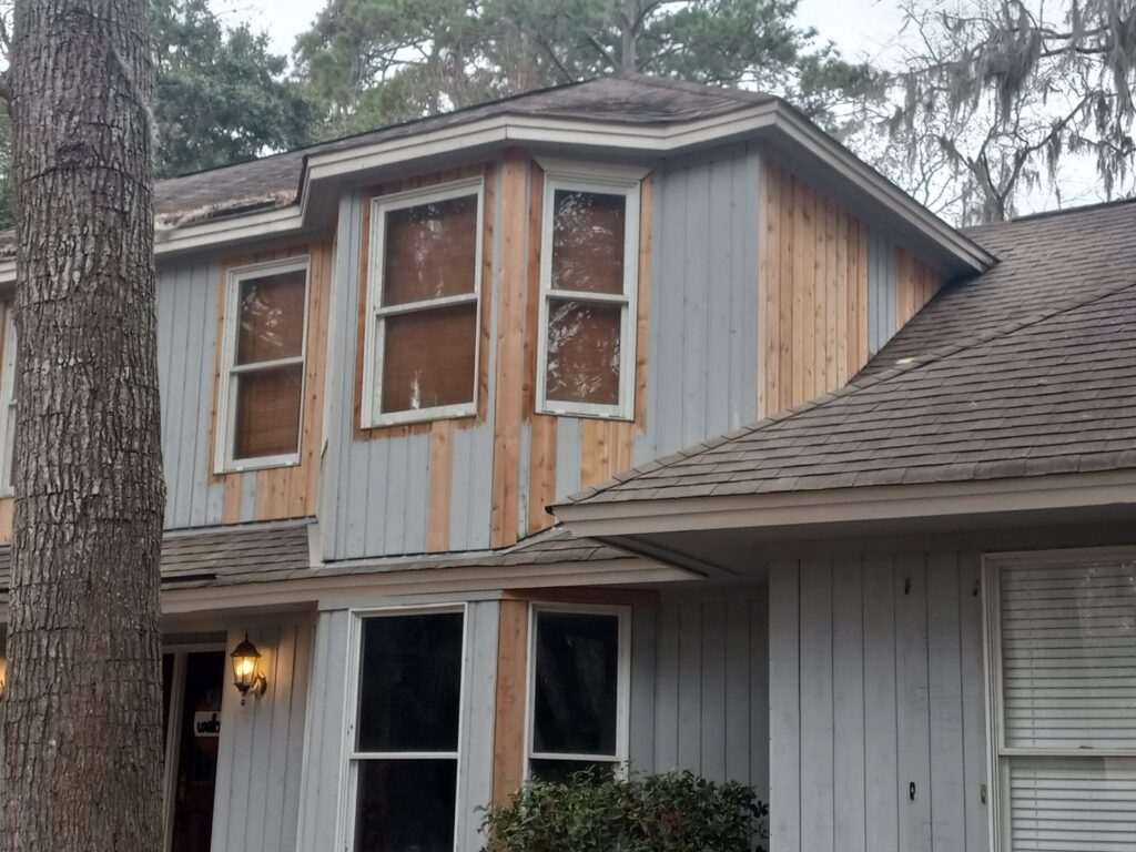 House with old siding being removed for replacement by Action Roofing and Siding Co in South Saint Paul, MN