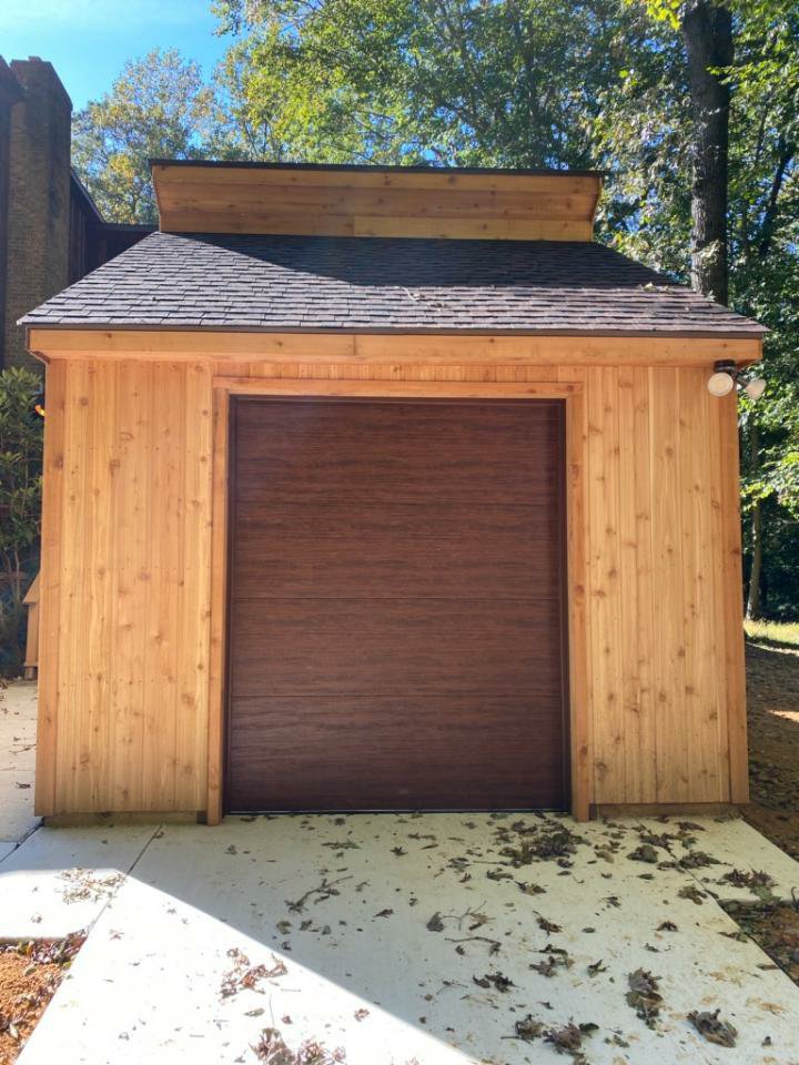 A single brown garage door installed on a wooden shed by Hickman Overhead Door in Milford, DE.