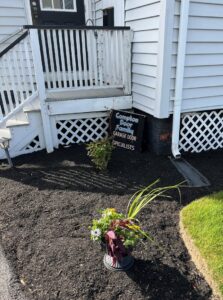 A single carriage-style garage door with X-brace design and windows installed by Compton Doors, Inc. in Attleboro, MA