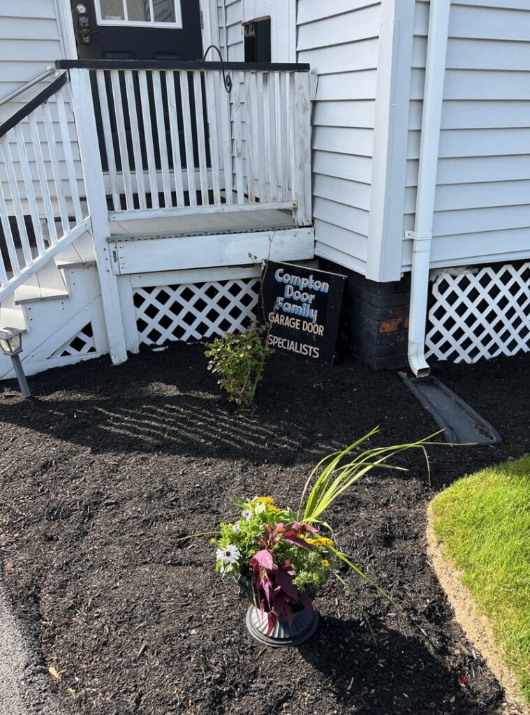 A single carriage-style garage door with X-brace design and windows installed by Compton Doors, Inc. in Attleboro, MA