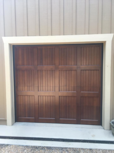 A single dark brown panel garage door installed by Advantage Door Company in Troy, MO.