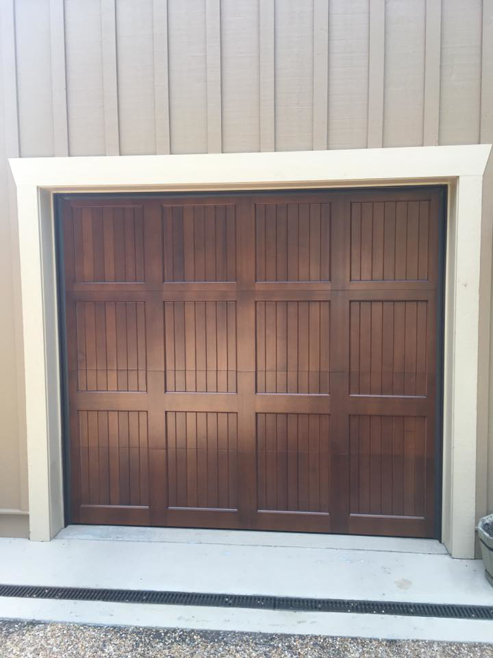 A single dark brown panel garage door installed by Advantage Door Company in Troy, MO.