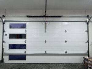 Interior view of a single white garage door with multiple windows, installed by Elite Doors in Wasilla, AK.