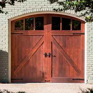 A single wooden garage door with an arched top and decorative hardware by Advance Garage Door, Inc. in Fargo, ND.