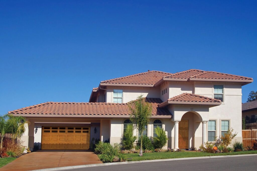A residential house featuring a single wooden garage door, likely installed by Overhead Door Company of Santa Fe in Santa Fe, NM.