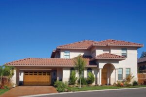 A residential house featuring a single wooden garage door, likely installed by Overhead Door Company of Santa Fe in Santa Fe, NM.