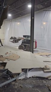 A skid steer removing debris during an interior demolition project by Allied Wrecking Boston in East Boston, MA.