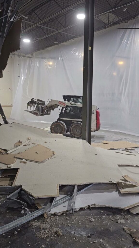 A skid steer removing debris during an interior demolition project by Allied Wrecking Boston in East Boston, MA.