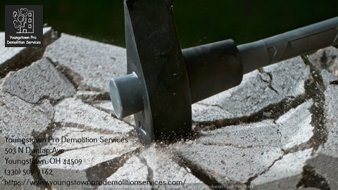 A sledgehammer breaking concrete pavement, a service provided by Youngstown Pro Demolition Services in Youngstown, OH.