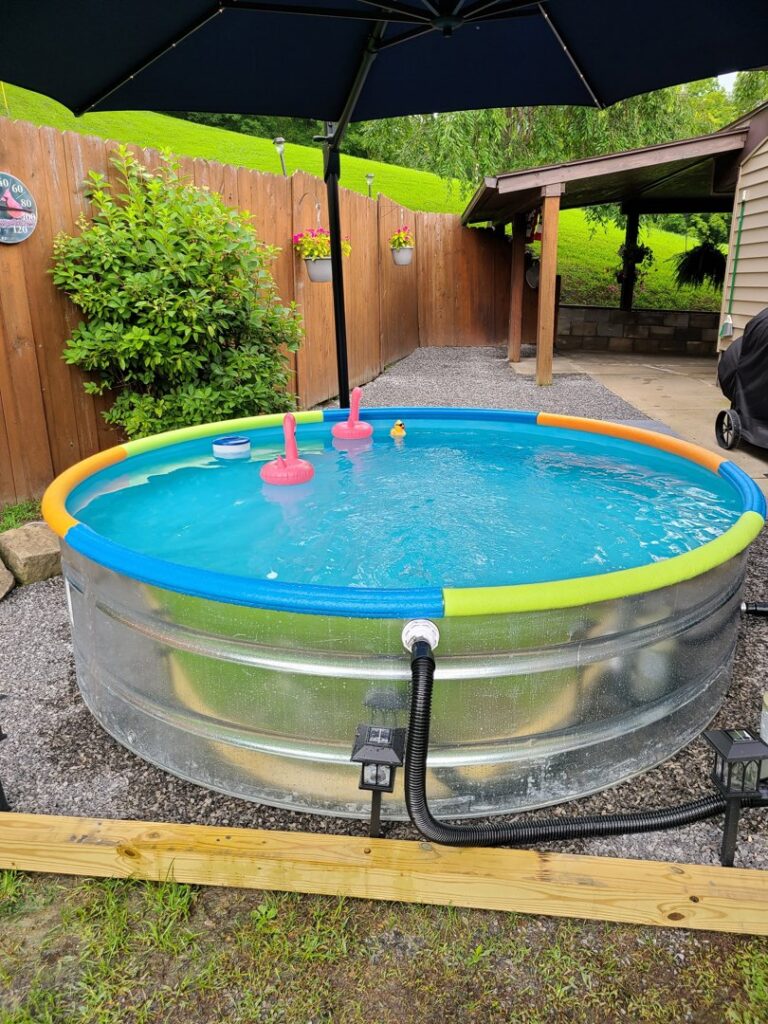 A small round stock tank pool with a connected pump system installed by Pool Queen in Fairmont, WV.