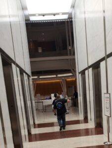 SNEEDWORKS movers entering elevators in a modern commercial building in Oklahoma City, OK, for a move.