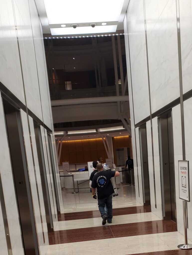 SNEEDWORKS movers entering elevators in a modern commercial building in Oklahoma City, OK, for a move.