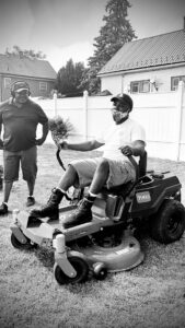 A snow blower actively clearing snow from a residential driveway, showcasing Knight's Landscaping & Snow Removal in Buffalo, NY.
