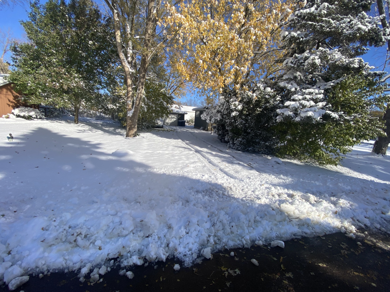 A residential driveway with snow piled on the side after clearing by Evo Lawn & Landscape LLC in Waukegan, IL.