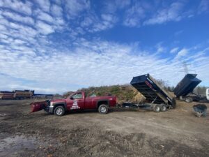 A red pickup truck equipped with a snow plow for snow removal services by Angel Landscape & Snow Services Inc. in Racine, WI.