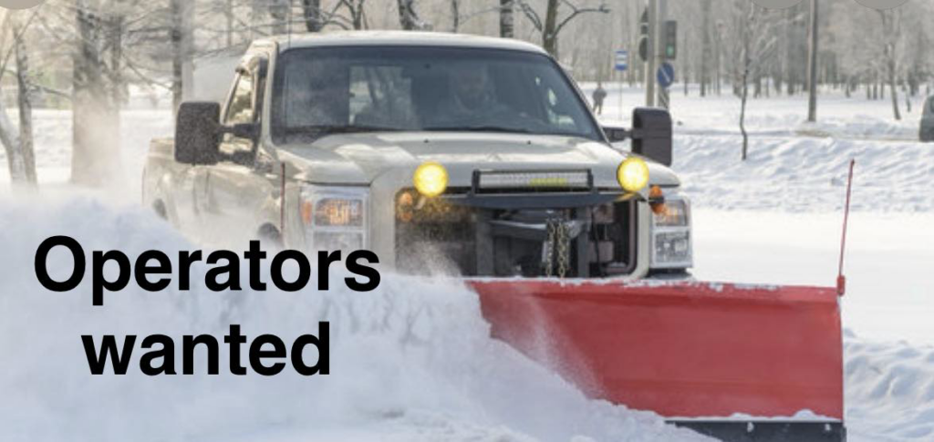 A white pickup truck with a red snow plow actively clearing snow from a road for Better Lawns & Snow Removal in Chatfield, MN.