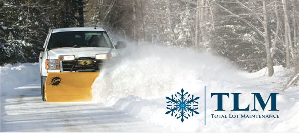 A snow plow truck actively clearing a snowy road, showcasing snow removal services by Total Lot Maintenance in St. Charles, MO.