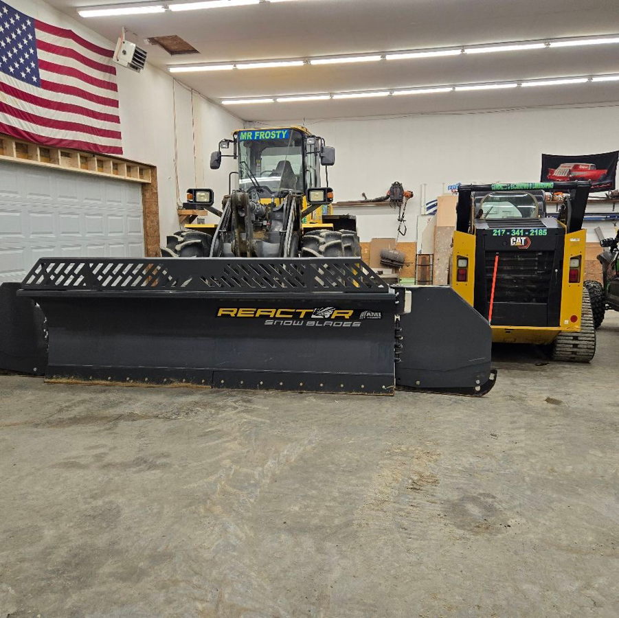Heavy snow removal equipment, including a skid steer with a Reactor snow blade, ready for service at Mr. Frosty Snow Removal in Springfield, IL.