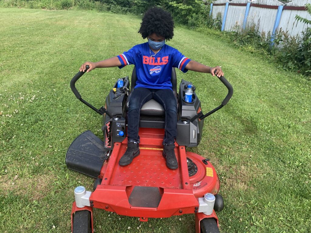 A snowplow truck actively clearing snow from a parking lot, provided by Knight's Landscaping & Snow Removal in Buffalo, NY.