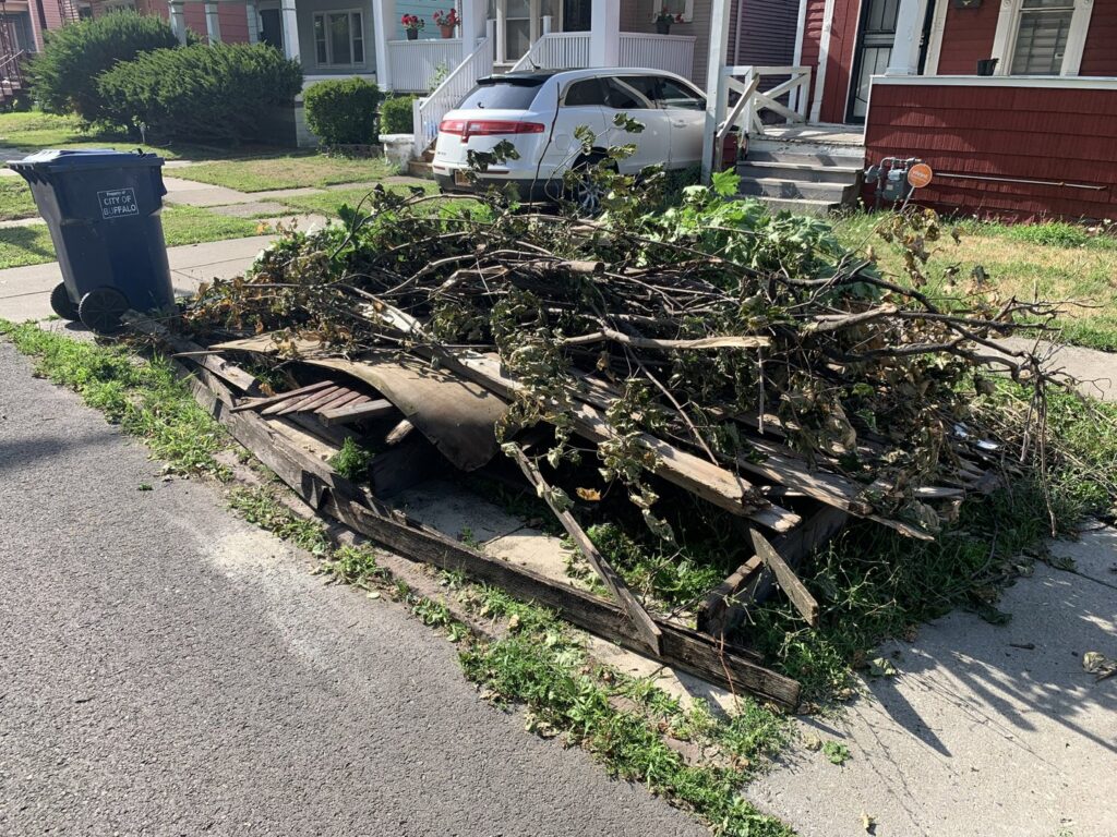 A snowplow truck actively clearing snow from a road, demonstrating services by Knight's Landscaping & Snow Removal in Buffalo, NY.