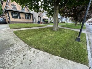 A snowplow truck actively clearing snow from a street, showcasing Knight's Landscaping & Snow Removal in Buffalo, NY.