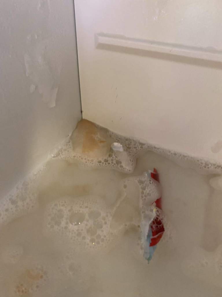 A sink filled with soapy water and debris, indicating a thorough cleaning process by Seabirds Cleaning in Saco, ME.