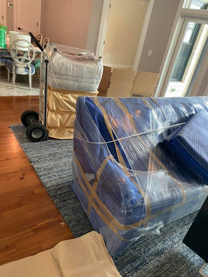 A sofa carefully wrapped in plastic and moving blankets, ready for transport by Miracle Movers of Charleston, SC in Summerville, SC.