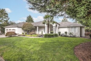 A spacious home with light-colored siding and decorative stone accents, a project by Lifetime Remodeling Systems in Portland, OR