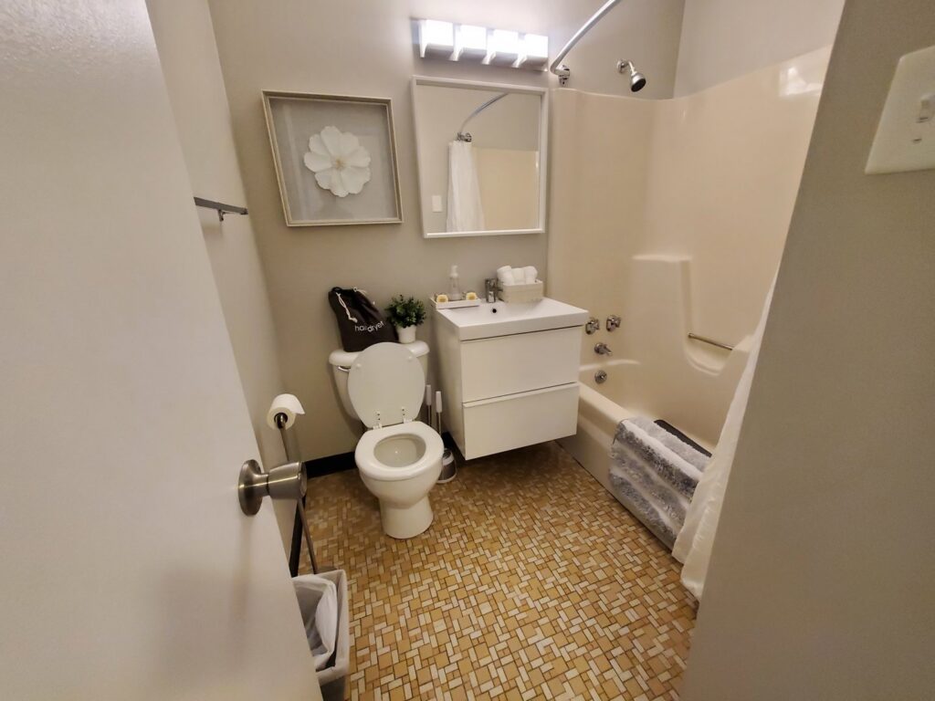 A sparkling clean bathroom with a toilet and bathtub, demonstrating the thorough cleaning service by Maids of Hartford in Hartford, CT.