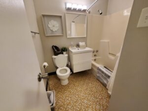 A sparkling clean bathroom with a toilet and bathtub, demonstrating the thorough cleaning service by Maids of Hartford in Hartford, CT.