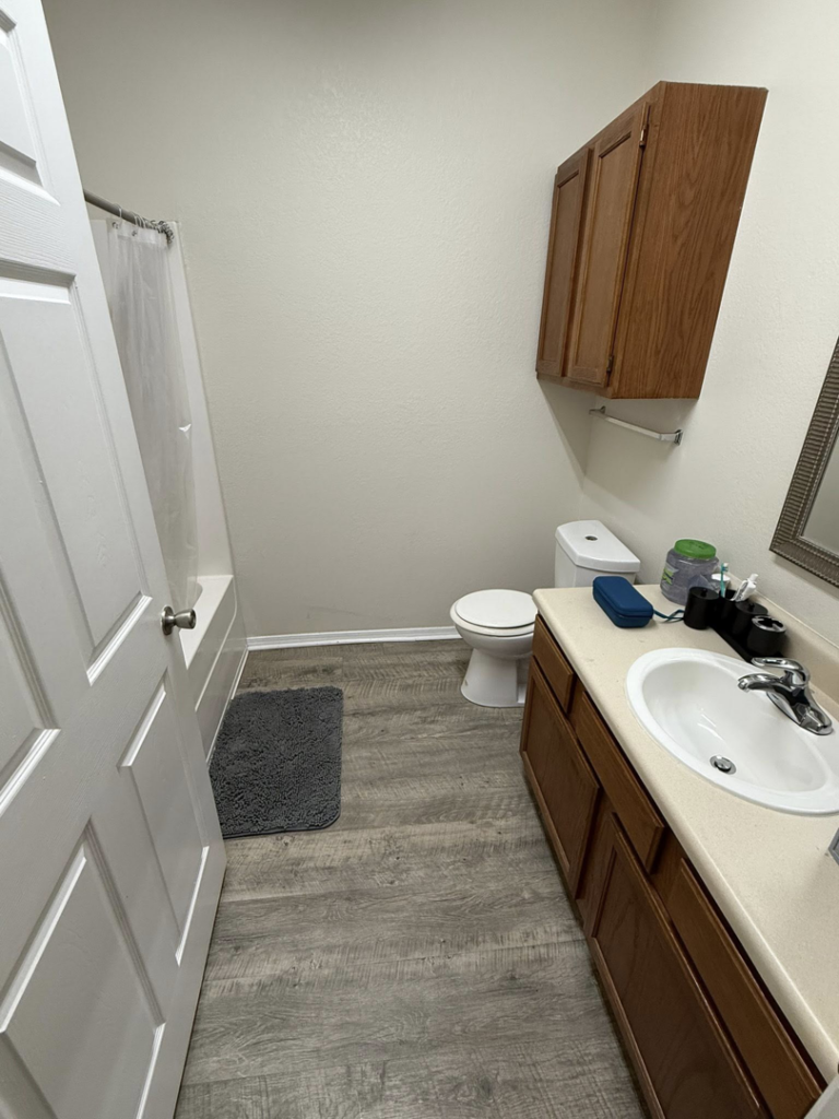 A sparkling clean and organized bathroom, showcasing the results of WWJM Cleaning Service in Oklahoma City, OK.
