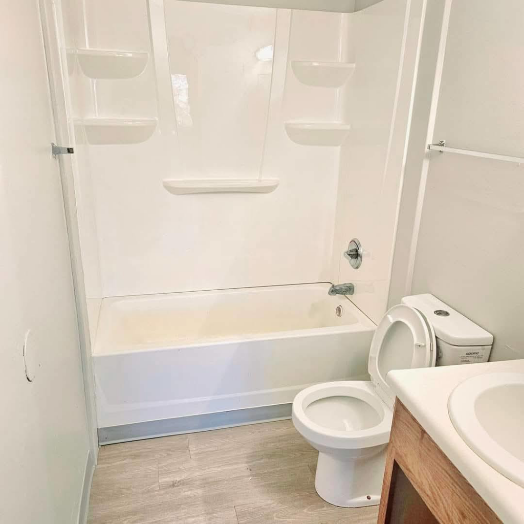 A sparkling clean bathroom with a white tub and toilet, demonstrating the quality cleaning by Mary's Magic Touch Janitorial Services in Akron, OH.