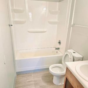 A sparkling clean bathroom with a white tub and toilet, demonstrating the quality cleaning by Mary's Magic Touch Janitorial Services in Akron, OH.