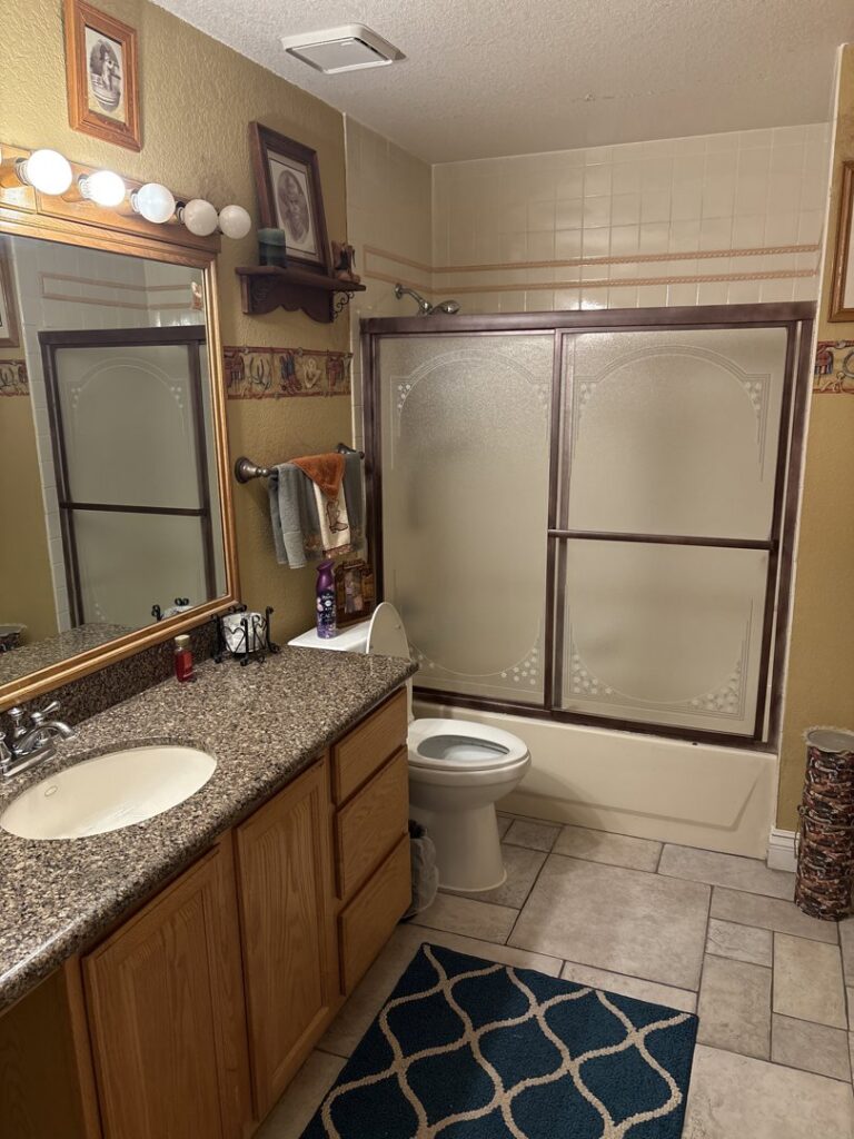 A sparkling clean bathroom with a vanity, mirror, toilet, and shower, showcasing the quality work of MaxPro Cleaning in North Las Vegas, NV.