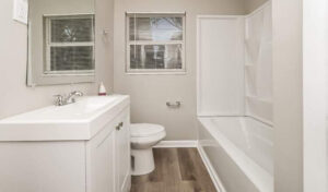 A sparkling clean bathroom with a white vanity and bathtub, showcasing the professional cleaning services of Perfection Cleaning in Kansas City, MO.