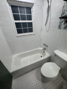 A sparkling clean bathroom with a white bathtub and toilet, showcasing the results of Pristine Cleaning Services in Thornton, CO.